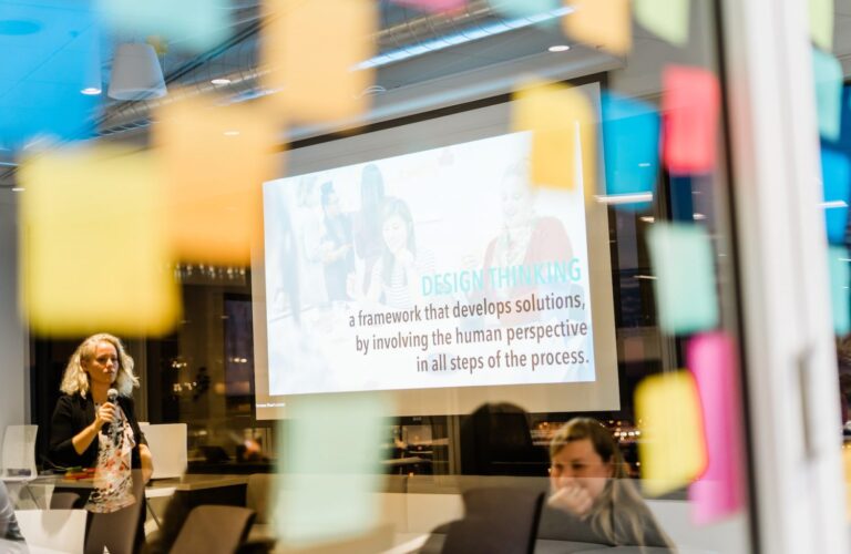 view of a large monitor in a glass conference room