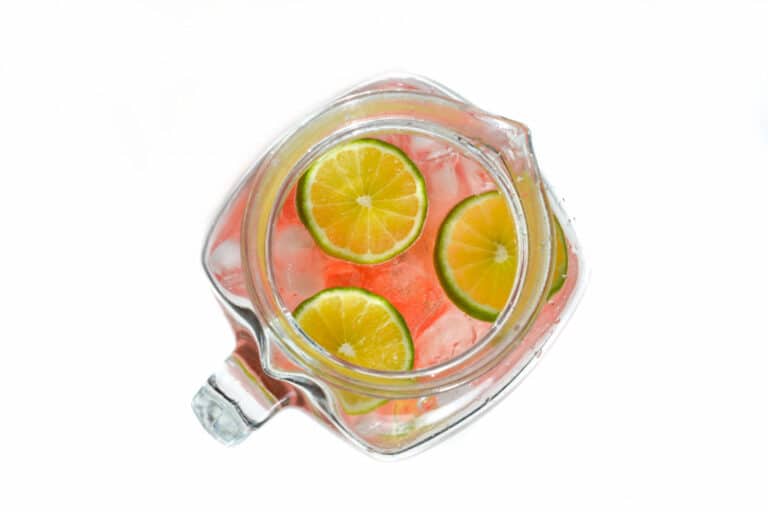 Overhead view of lime slices floating in a pitcher of punch