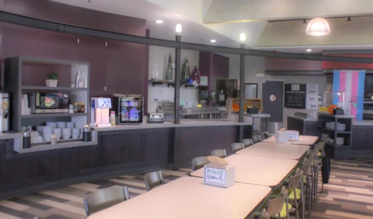 Long table and food service area in a school lunchroom