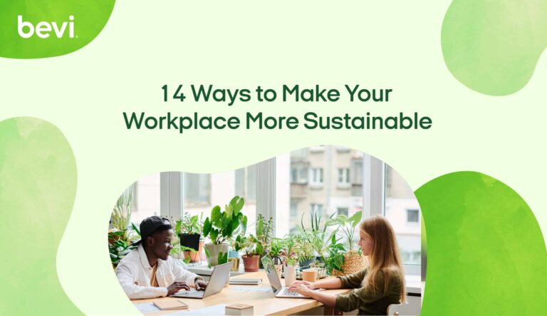 Photo of 2 young adults working at a large desk surrounded by windows and plants with the caption "14 ways to make your office more sustainable"