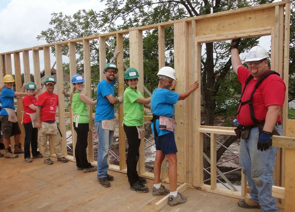 Volunteers framing a house