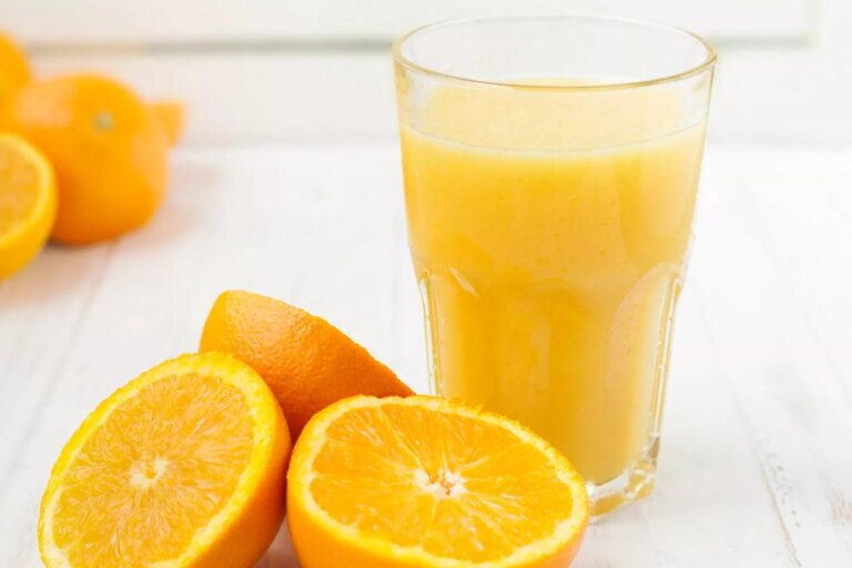 Orange halves with a glass of orange juice