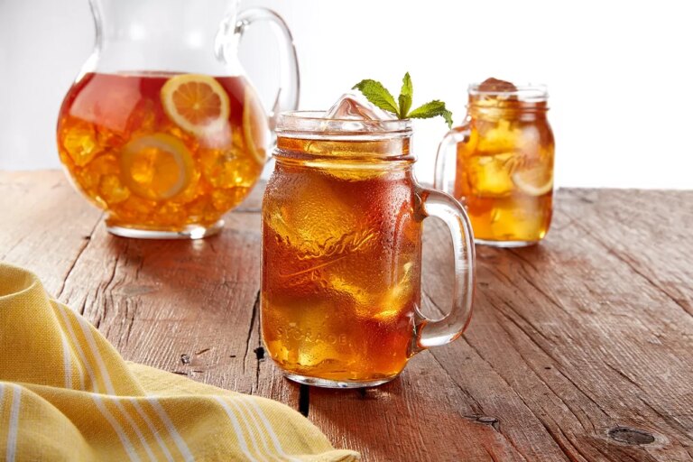 Mason jar drinking glass filled with iced tea