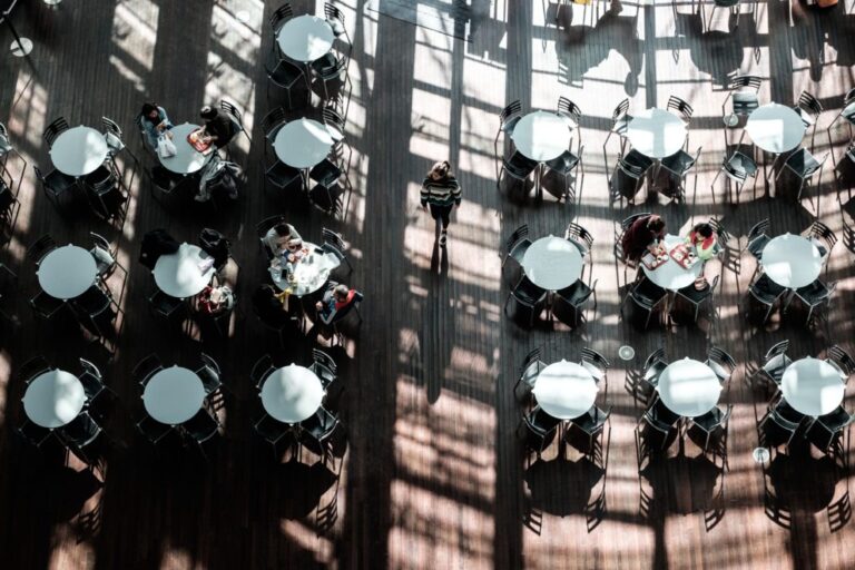 Overhead view of several tables and chairs in an outdoor dining area