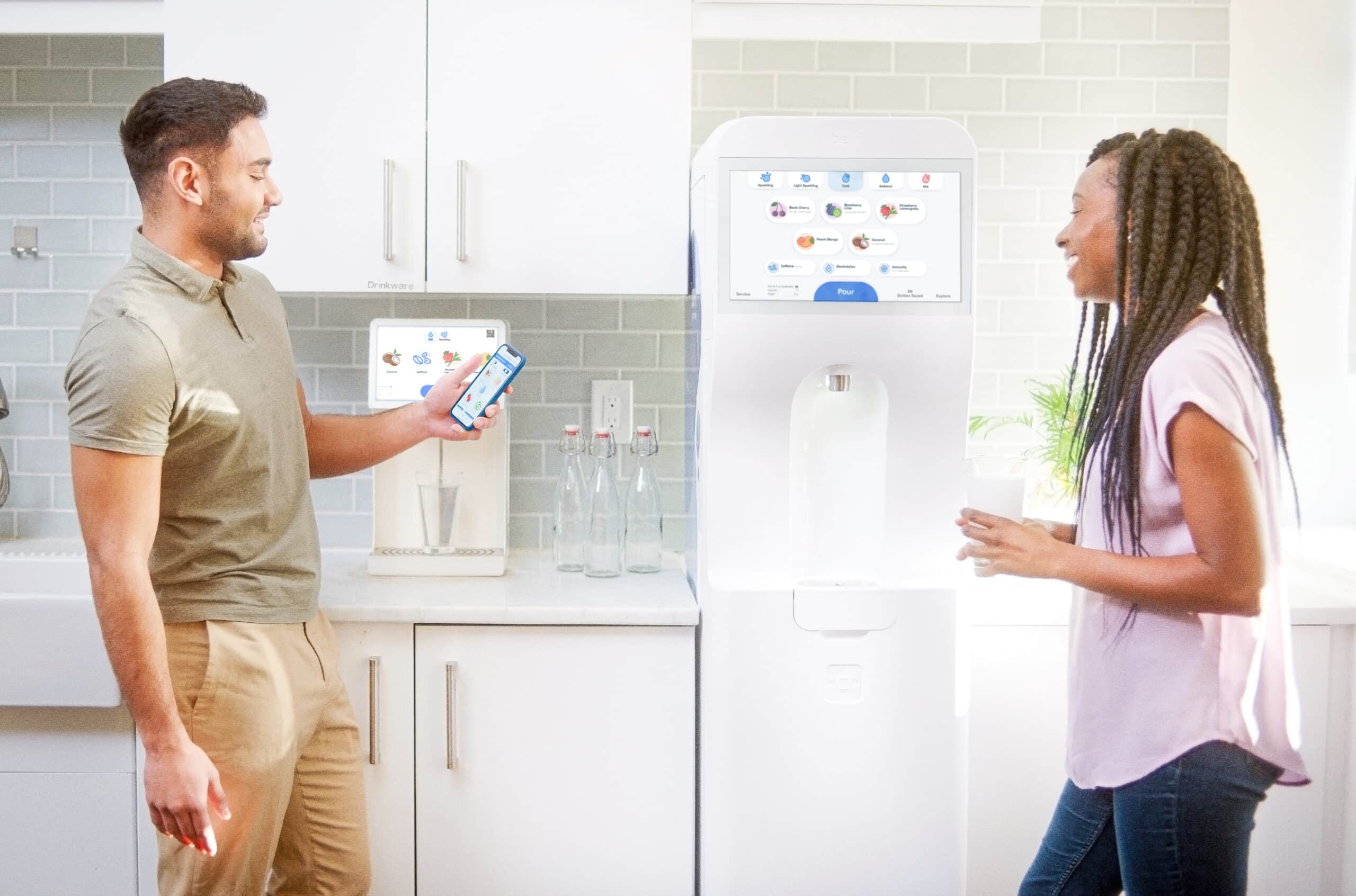 two people talking in front of bevi machines