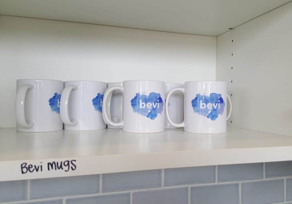 Row of Bevi coffee mugs on a kitchen counter