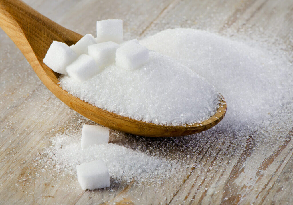 Sugar on wooden table. Selective focus