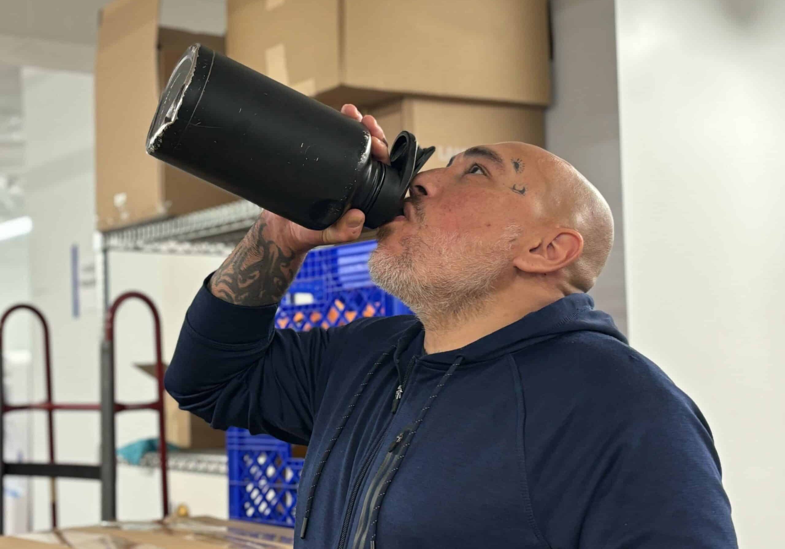 Man enjoying Bevi water with electrolytes in the break room.