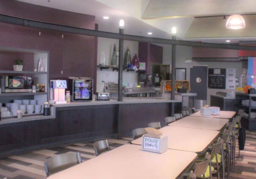 Long table and food service area in a school lunchroom